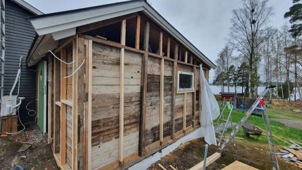Fasadmålning med panelbyte i Stockholm - Panelen passas in noggrant kring fönster och knutar.