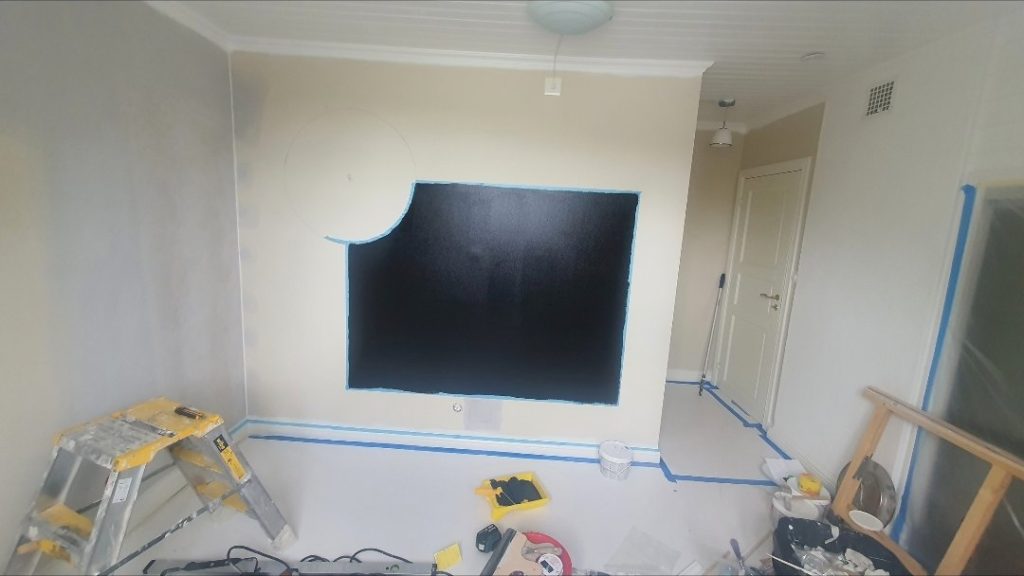 Invändig målning i Stockholm - Arbetet pågår - ytan maskad och första svarta strykningen på plats.
